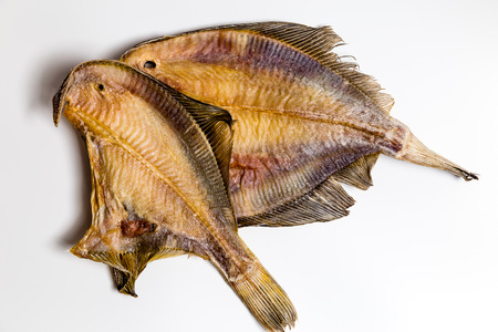 dried flounder lie on a white backgroundの写真素材