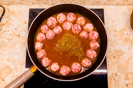 preparation of meatballs in a frying pan at homeの写真素材