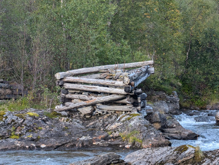 Rustic Log Structure by Riverの写真素材