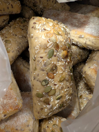 Close-up of multigrain bread rolls with seeds and oats on crustの写真素材