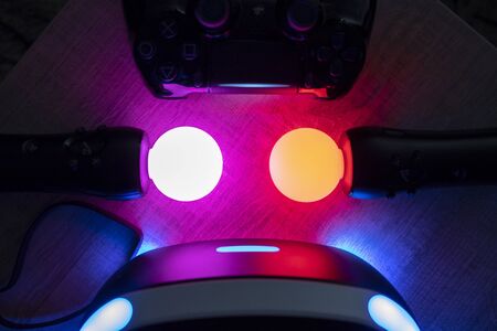 Brecht, Belgium - June 12 2019: A dark close up of a turned on playstation VR headset together with...