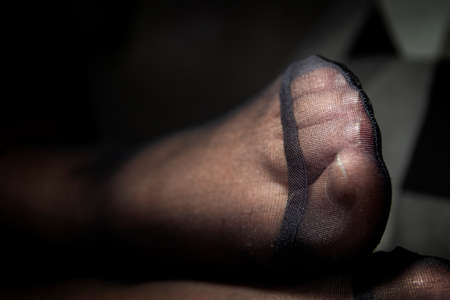 A portrait of a black pantyhose foot zoomed in at the reinforced nylon at the toes.の写真素材