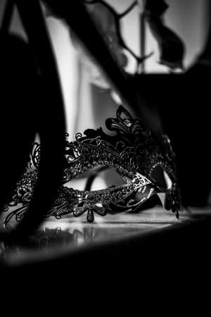 A portrait of a venetian mask lying on a marble windowsill ready to hide your identity at a party or carnival and create mystery.の写真素材