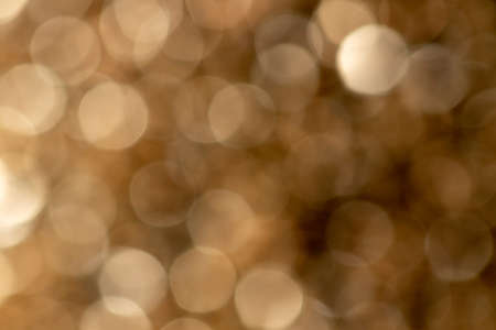 A portrait of a nice gold color bokeh background. The golden blur is something magical.の写真素材