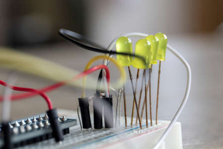 A portrait of a some electronics, it is a bread board with some LED's attached onto it, with some wires.の写真素材