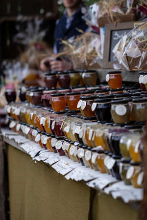 BEERVELDE, BELGIUM - MAY 12 2019: A portrait of a market stall selling nothing but pots of jam. They come in all sorts of flavors of fruit and mixed fruits.のeditorial素材