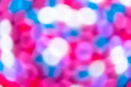 An abstract colorful blurry art background of different colors. The bokeh balls are pink, red, purple, white and blue.の写真素材