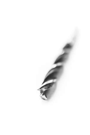 A black and white studio portrait of a spiral high speed steel wood drill bit on a white background. The metal tool is used to drill holes into wood for build or repair or construction work.の写真素材