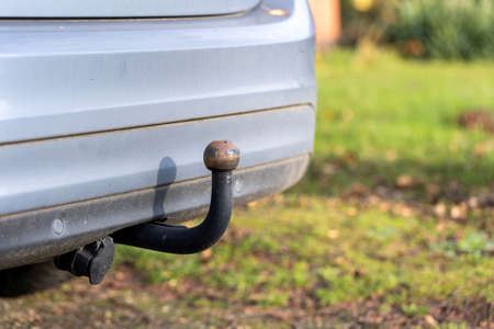 A portrait of the bumper at the back of a car with a tow bar under it for pulling small trailers or...