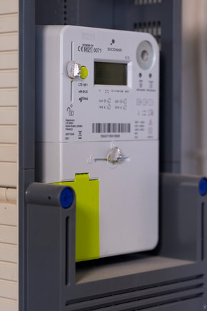 Brecht, Belgium - January 26, 2023: Portrait of a new installed Belgian digital electricity kilowatt hour meter. The device is used by the provider to calculate the power usage for the customer.のeditorial素材