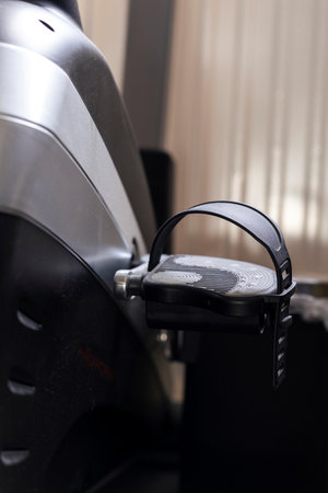 A portrait of the pedal of a home trainer or training bike standing indoors. The machine is ready to...