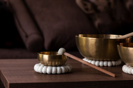 A close up of a tibetan singing bowl or himalayan bowl, with a mallet leaning on the side of it to make a relaxing sound. The object is used for relaxation, meditation and therapy to relieve stress.の写真素材