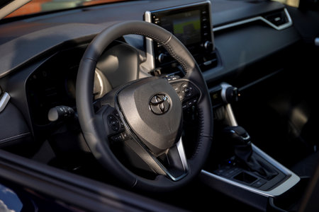 Brecht, Belgium - February 5, 2022: A portrait of a black toyota rav4 steering wheel and interior inside of the car, with sunlight hitting the driver side.のeditorial素材