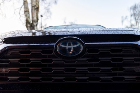 Brecht, Belgium - January 21, 2022: A closeup portrait of the front toyota logo of a dark blue rav4...