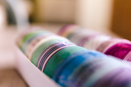 Colorful washi tape in different patterns and colors in a box. The decorative rolls are ready to use for interior design like on a wall or to decorate a gift or post card, gift or for some to use.の写真素材