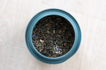 A portrait of dried loose fresh marrakech mint tea in a blue can. Ready to be used to make a delicious fresh cup of the warm beverage for some soothing relaxation and zen time.の写真素材