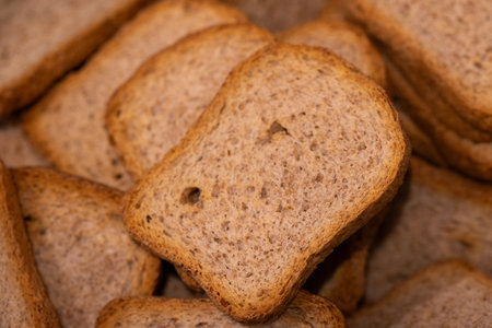A portrait of a pile of multiple crispy tasty delicious rusk, sea biscuit or hardtack biscuits, ideal food for a lunch, brunch or quick snack with jam or jelly or chocolate spread.の写真素材
