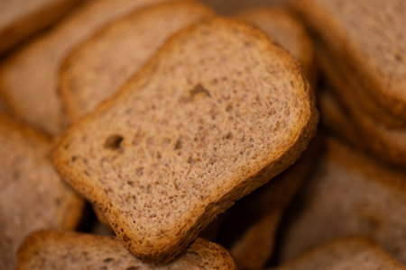 A portrait of a pile of multiple delicious crispy tasty hardtack, sea biscuit or rusk biscuits, ideal food for a lunch, brunch or quick snack with jam or jelly or chocolate spread.の写真素材