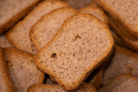 A portrait of a pile of multiple crispy delicious tasty rusk, sea biscuit or hardtack biscuits, ideal food for a lunch, brunch or quick snack with jam or jelly or chocolate spread.の写真素材
