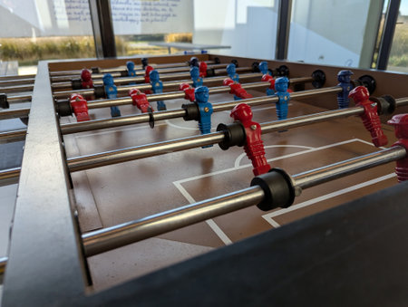 A close portrait of a foosball table at the level of the miniature plastic soccer or football players. they are ready to be played with.の写真素材
