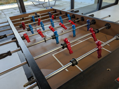 A top down view of a foosball table, all the miniature plastic soccer or football players are visible and the handles to. they are ready to be played with.の写真素材