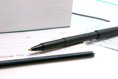 Checkbook, bill, and pen.の写真素材