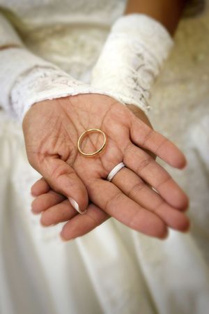 Hispanic bride's hands holding groom's wedding band, shallow dofの写真素材