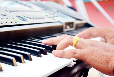Musician playing piano outdoors. /Selective focus. /Daylighting