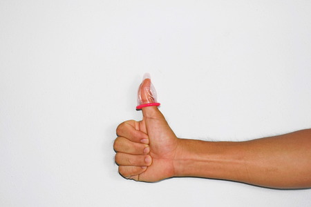 Condoms were worn on the thumb. /How to Use. /Represents emotions and ideas.の写真素材