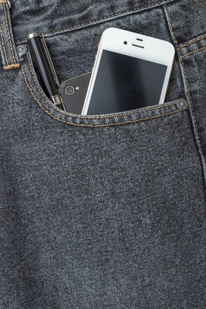 Close up of smart phone in pocket jeansの写真素材