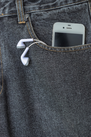 Close up of smart phone in pocket jeansの写真素材