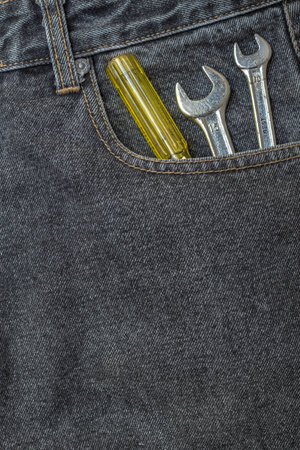 black jeans pocket with chrome lug wrenchの写真素材