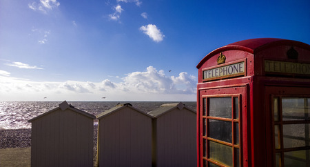 BT GPO red telephone box on a beach, public use call payphone Taken OCT 2014 on exmouth beach, devon, ukの写真素材