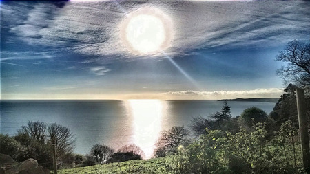 2013 hdr image with effects added to give a surreal look at the sun looking out to see at strete in devon ukの写真素材