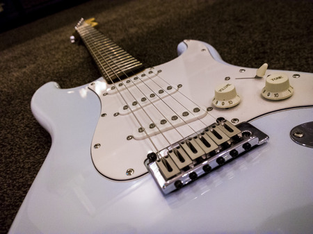 Squier Stratocaster electric guiat shown on a carpet in daphine blue