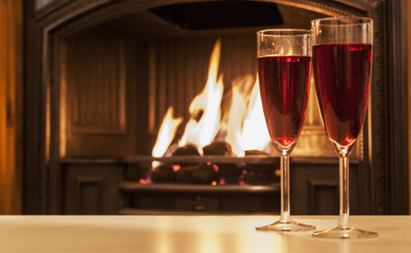 2 wine glasses shown by a open fireの写真素材