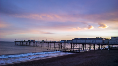 Teignmouth pier at sunset, with a red skyの写真素材