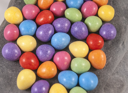Easter mini eggs shown on a grey slate tile,
