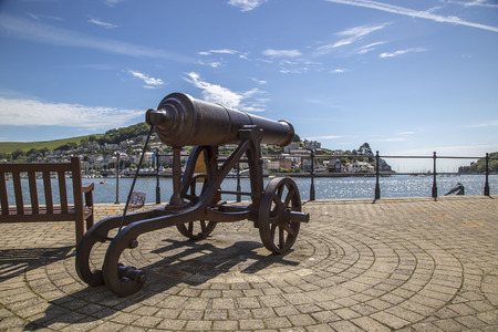 Dartmouth Devon UK JUNE 4 2015  Showing an old cannon sat next to a seaside townのeditorial素材
