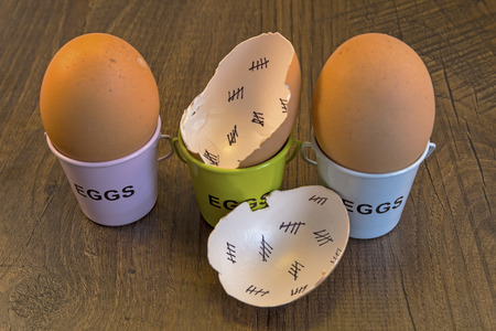 Egg shells with egg cups shown lying with on a wooden with marks inside counting down the days till...