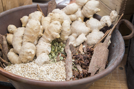 Showing raw ingredients and ginger in a bowlのeditorial素材