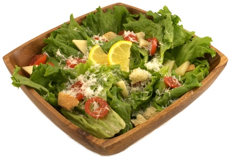 A free salad of lettuce, tomatoes, and cheese in wooden bowls の写真素材