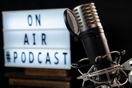 Podcast setting with microphone and a light sign reading âon airâの写真素材