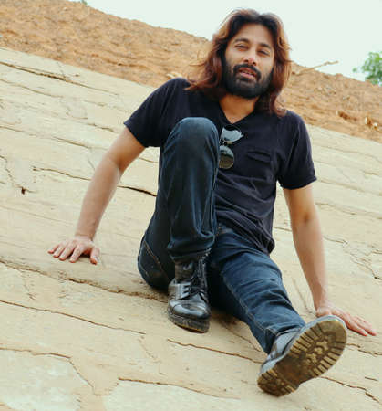 Street Fashion of stylish Long hair with beard man in a isolated placeの写真素材