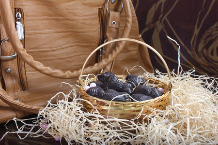 home made chocolates in metal basket with lady brown purseの写真素材