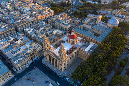 Aerial View of Valletta at Sunset The Glowing Baroque Architecture of St. Publius Church and Florianaの写真素材