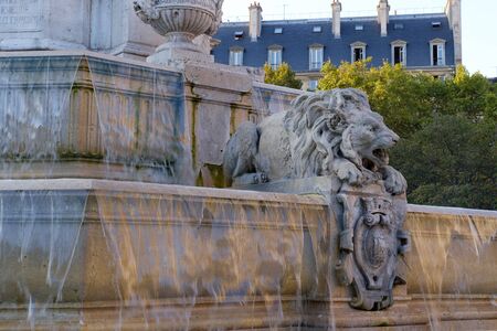 Lion statue in fountain Saint-Sulpice with pouring water in Paris, Franceの写真素材