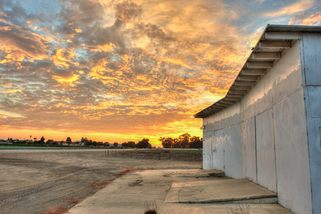 Wooden shack closed and locked under cloudy skies.の写真素材