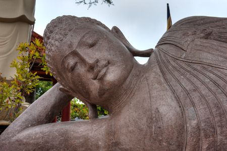 Buddhist statue close up lying on sideの写真素材