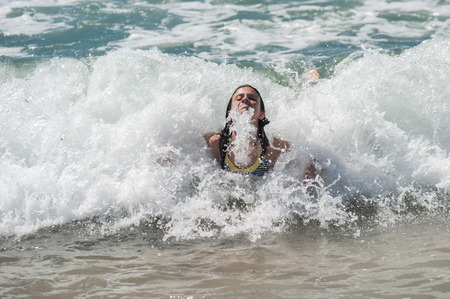 Girl child Body surfing the California waves